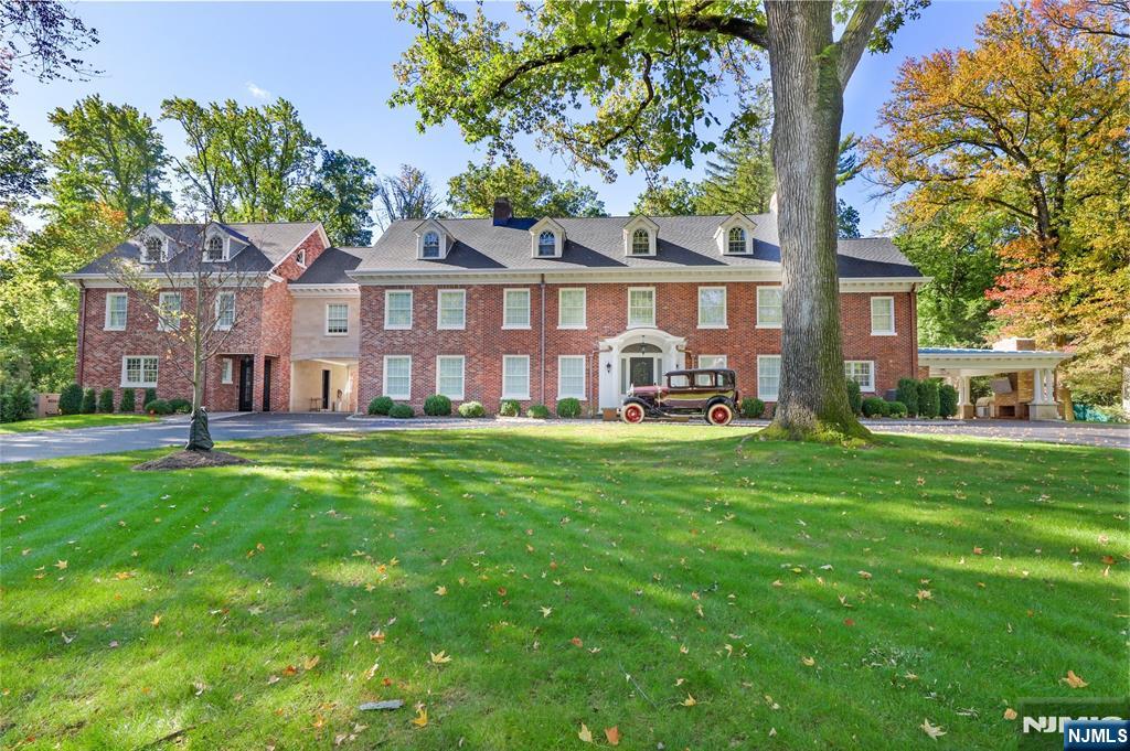 a front view of a house with a yard table and chairs