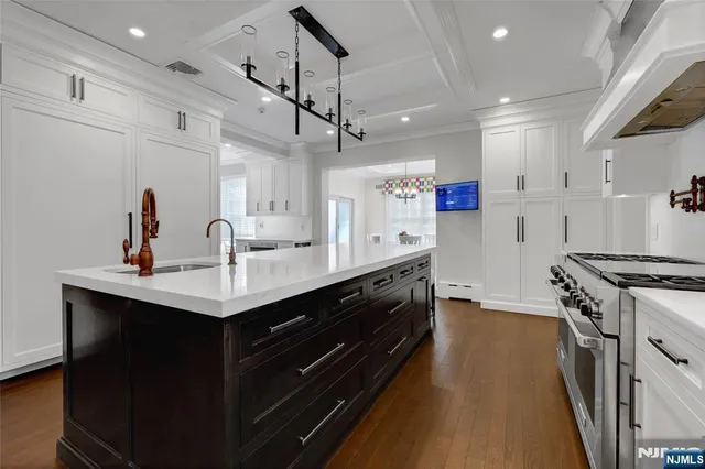 a kitchen with a sink stainless steel appliances and counter space