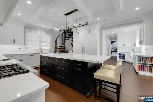 a kitchen with a table chairs stove and cabinets