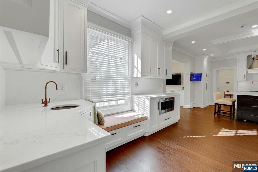 292 Maple Street Englewood, NJ 07631 - Photo 13 of 48 a kitchen with stainless steel appliances granite countertop a sink a stove and a refrigerator
