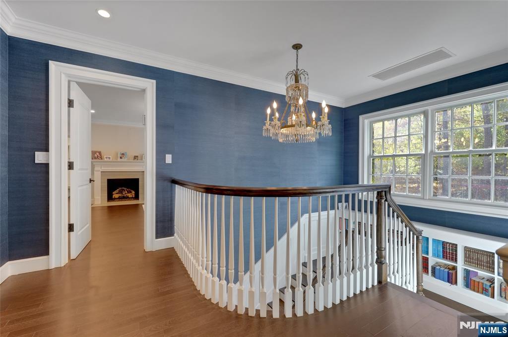 292 Maple Street Englewood, NJ 07631 - Photo 19 of 48 a view of a bedroom with furniture wooden floor and fireplace