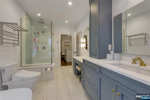 a spacious bathroom with a shower a sink and a mirror