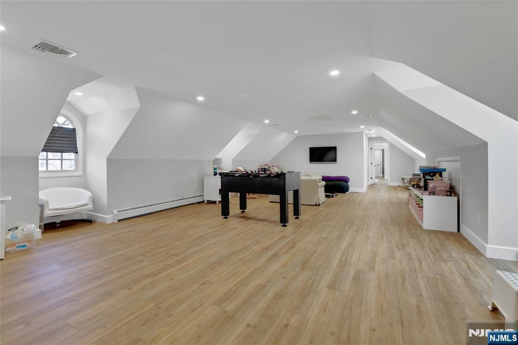 292 Maple Street Englewood, NJ 07631 - Photo 30 of 48 a living room with furniture and a flat screen tv