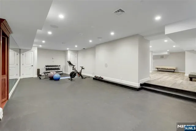 a large room with gym equipment and a large window