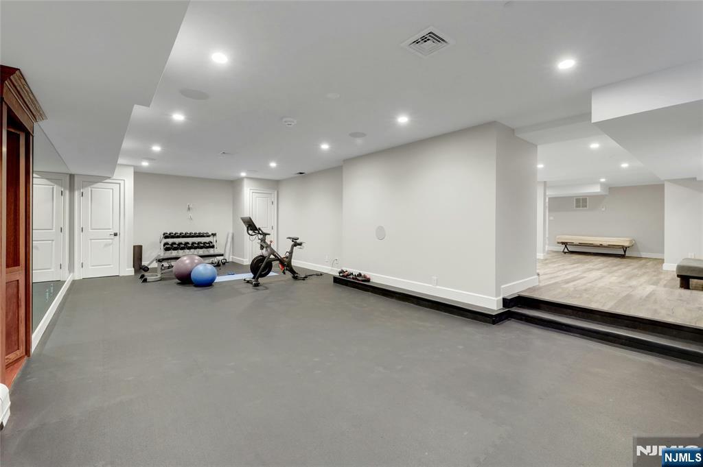 292 Maple Street Englewood, NJ 07631 - Photo 39 of 48 a large room with gym equipment and a large window