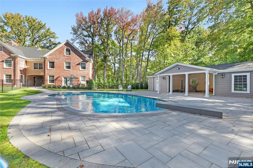 292 Maple Street Englewood, NJ 07631 - Photo 40 of 48 a front view of a house with a yard and trees