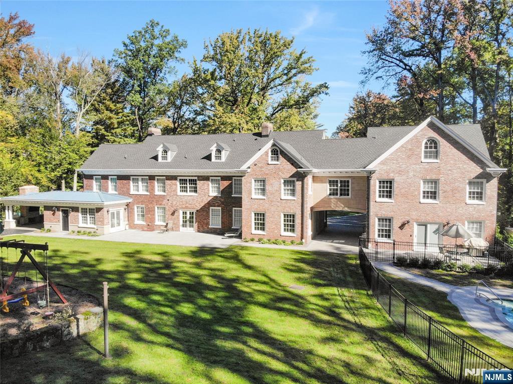 292 Maple Street Englewood, NJ 07631 - Photo 45 of 48 a front view of a house with a yard table and chairs