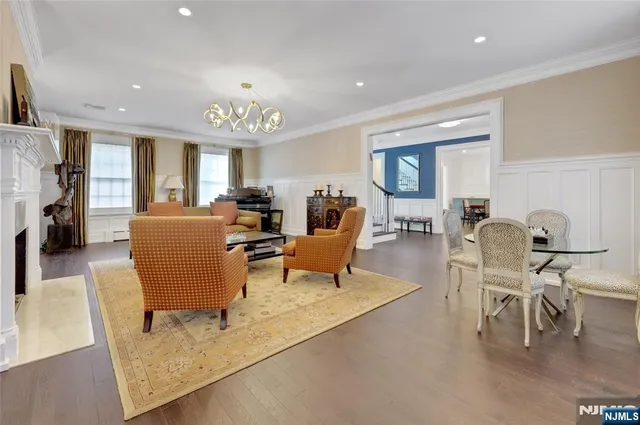 a living room with furniture a dining table and chairs with kitchen view