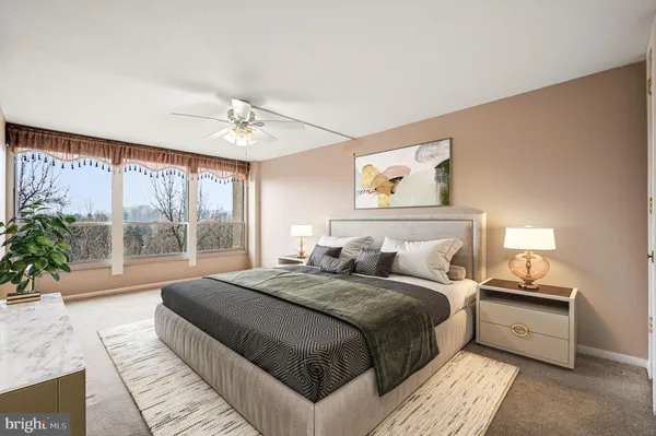 a bedroom with a large bed and a large window