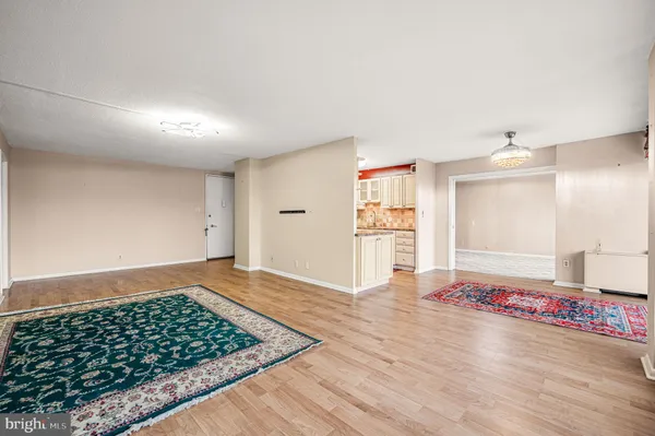 a view of an empty room and wooden floor