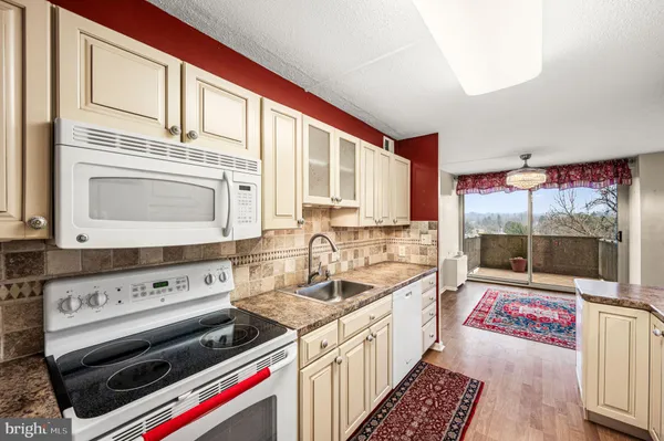 a kitchen with a stove a sink and a cabinets