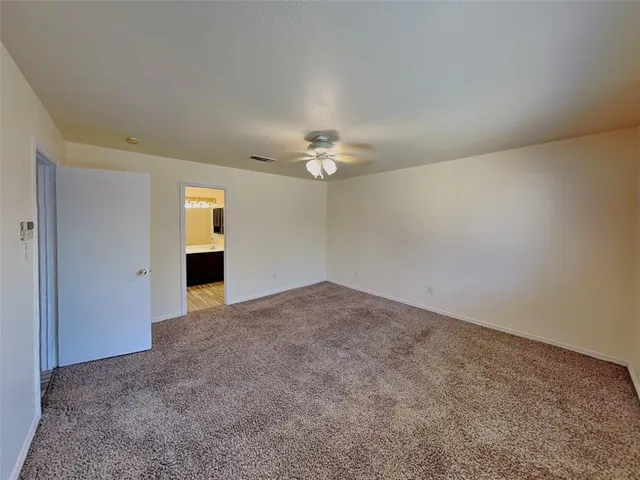 a view of a livingroom with a ceiling fan and window