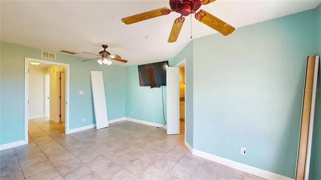 a view of a room with a ceiling fan and bathroom