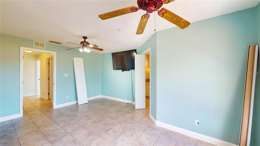 1193 Sand Mountain Road Fort Meade, FL 33841 - Photo 18 of 33 a view of a room with a ceiling fan and bathroom