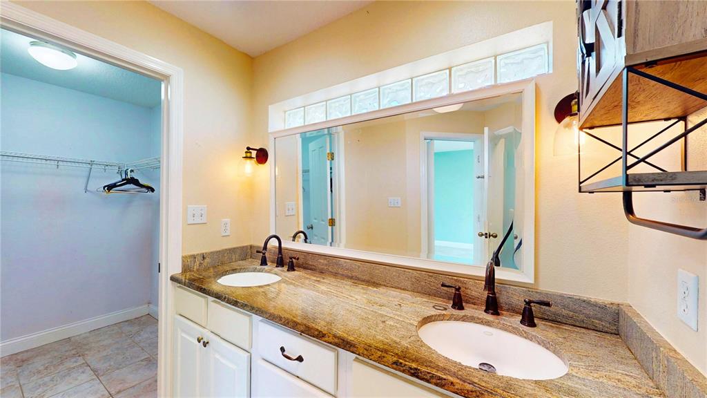 1193 Sand Mountain Road Fort Meade, FL 33841 - Photo 19 of 33 a bathroom with a granite countertop sink and a mirror