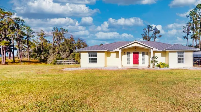 a front view of house with yard and swimming pool