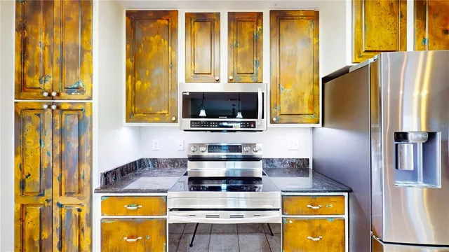 a kitchen with a stove and a refrigerator