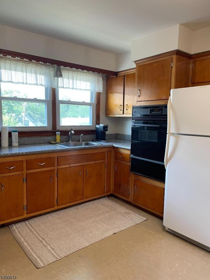 623 Bloomfield Avenue West Caldwell, NJ 07006 - Photo 4 of 13 a kitchen with granite countertop a stove a sink and a refrigerator