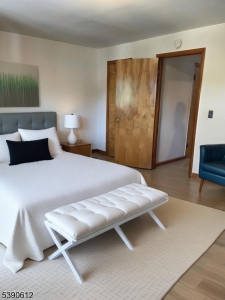 623 Bloomfield Avenue West Caldwell, NJ 07006 - Photo 6 of 13 a bedroom with a bed and a mirror