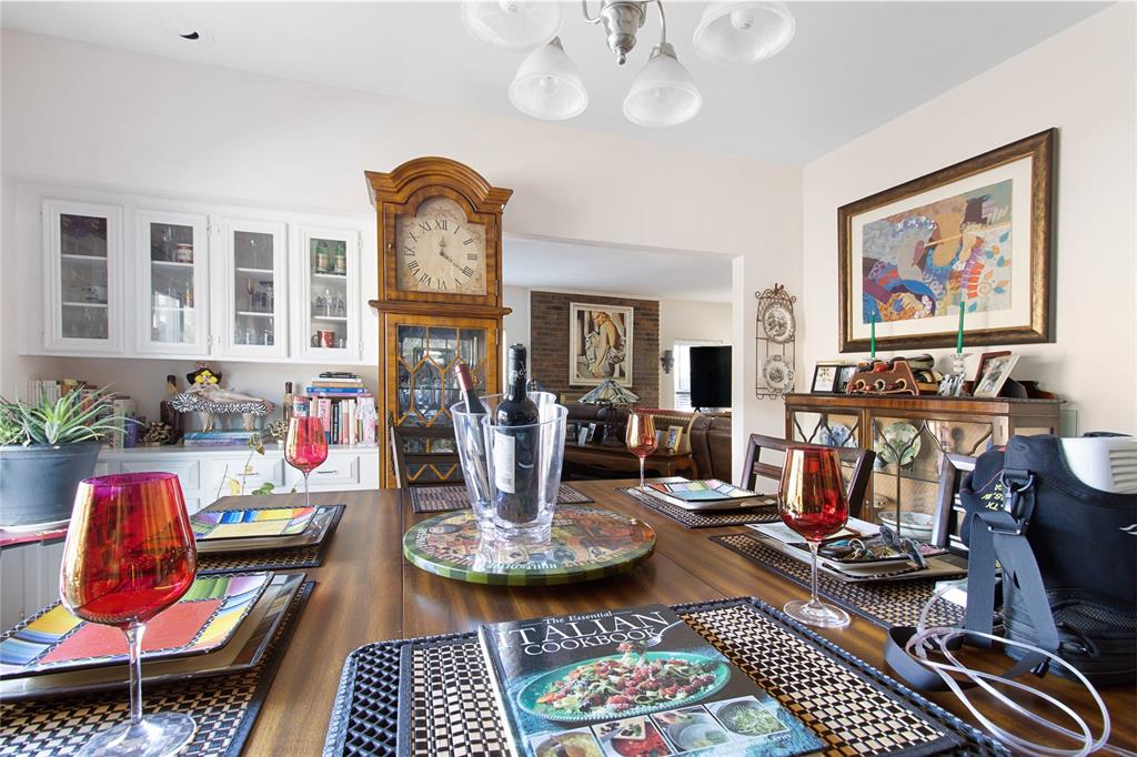 4988 Thunder Road Dallas, TX 75244 - Photo 11 of 31 a living room with furniture a flat screen tv and kitchen view