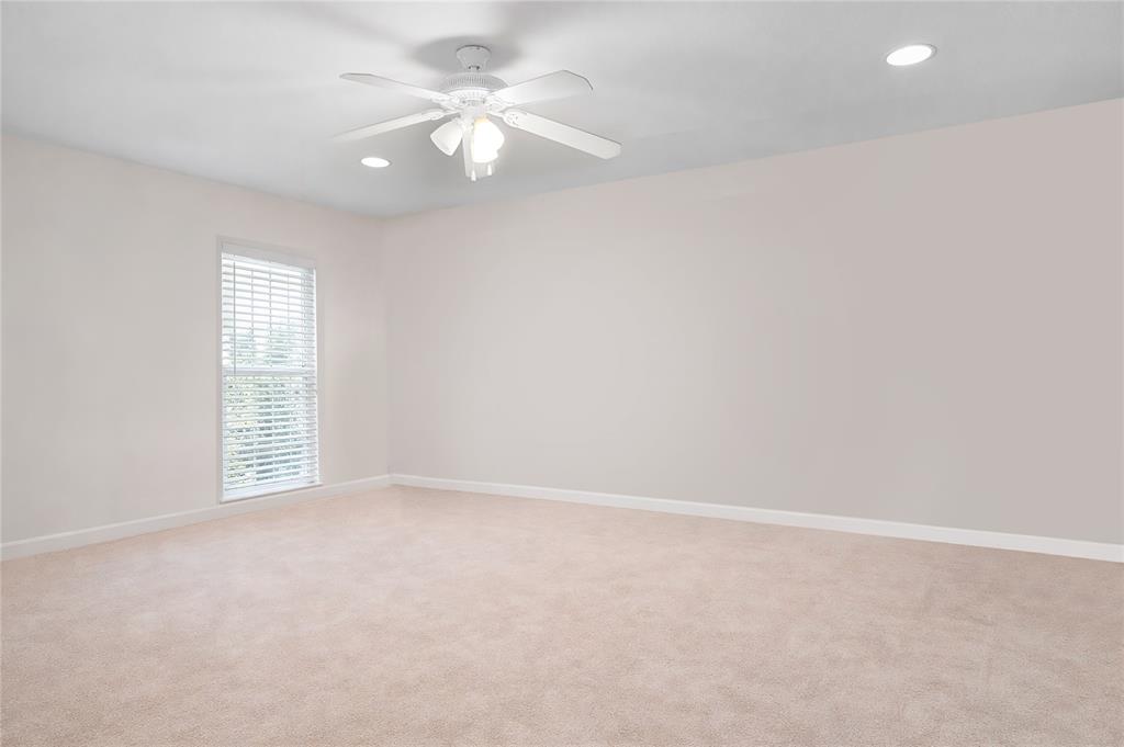 4988 Thunder Road Dallas, TX 75244 - Photo 18 of 31 an empty room with windows and fan