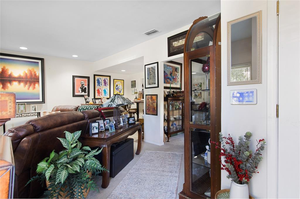 4988 Thunder Road Dallas, TX 75244 - Photo 2 of 31 a living room with furniture potted plant and a flat screen tv