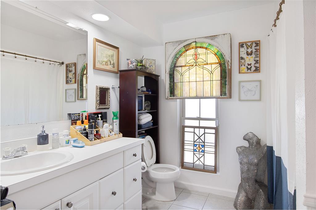 4988 Thunder Road Dallas, TX 75244 - Photo 21 of 31 a bathroom with a toilet sink and mirror