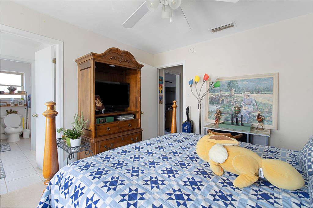 4988 Thunder Road Dallas, TX 75244 - Photo 23 of 31 a bedroom with a bed and a flat screen tv