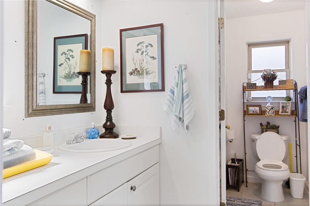 4988 Thunder Road Dallas, TX 75244 - Photo 24 of 31 a bathroom with a sink vanity mirror and toilet