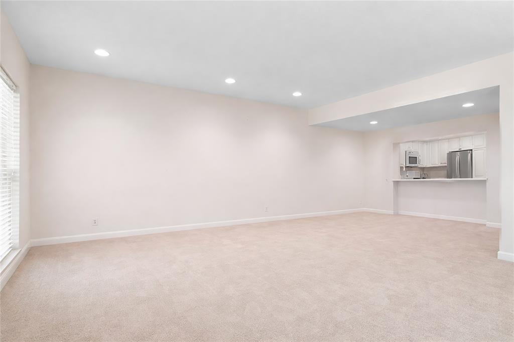 4988 Thunder Road Dallas, TX 75244 - Photo 5 of 31 an empty room with a kitchen and a sink