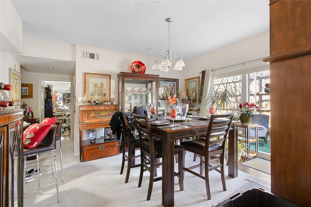4988 Thunder Road Dallas, TX 75244 - Photo 8 of 31 a view of a dining room and livingroom with furniture wooden floor a rug a flat screen tv and a clock