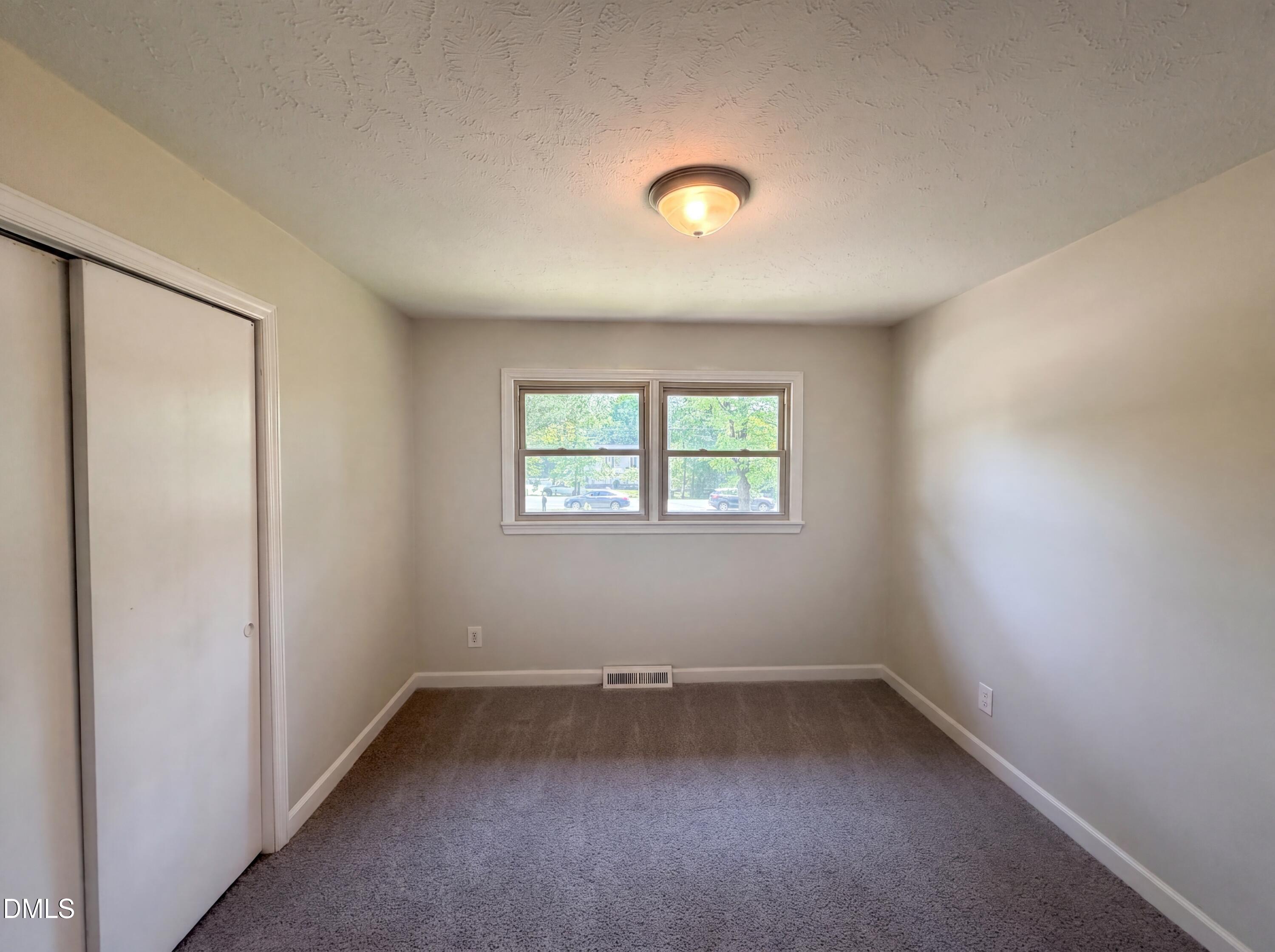 1710 West B Street Butner, NC 27509 - Photo 6 of 14 an empty room with a window