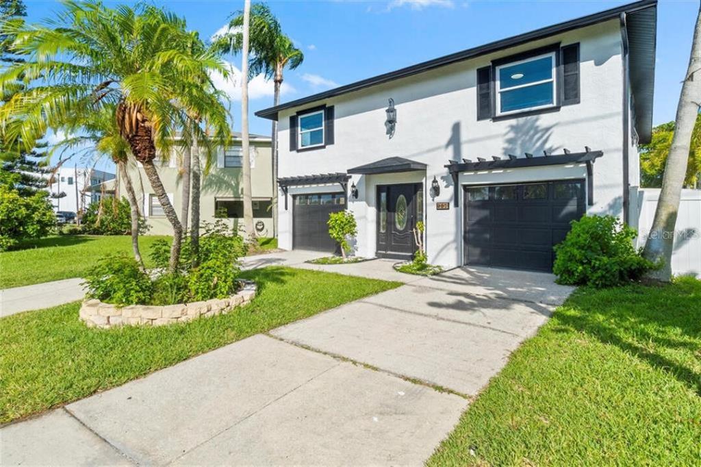 307 161st Avenue Redington Beach, FL 33708 - Photo 4 of 39 a front view of a house with garden