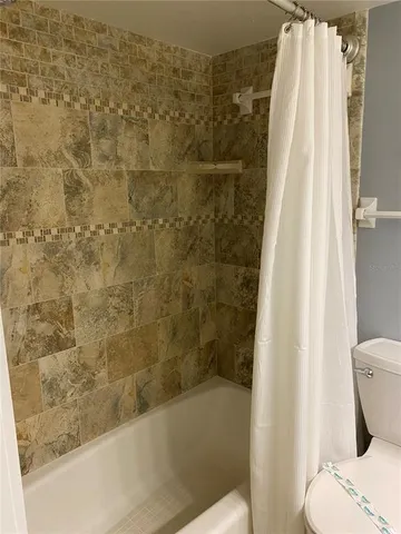 a bathroom with a toilet and shower