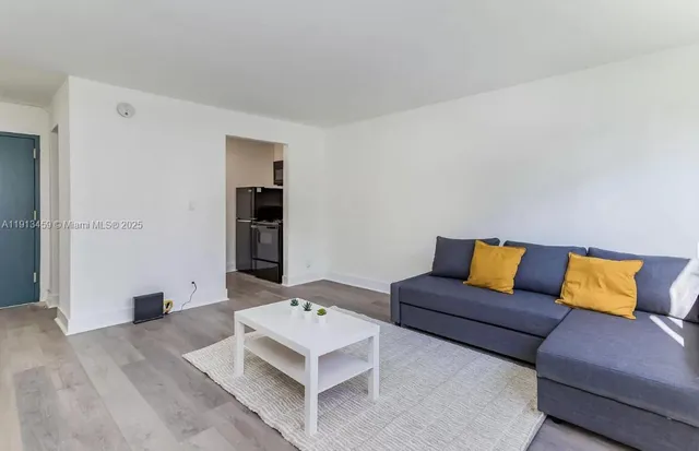 a living room with furniture and painting on the wall