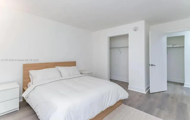 a bedroom with a bed and a night stand