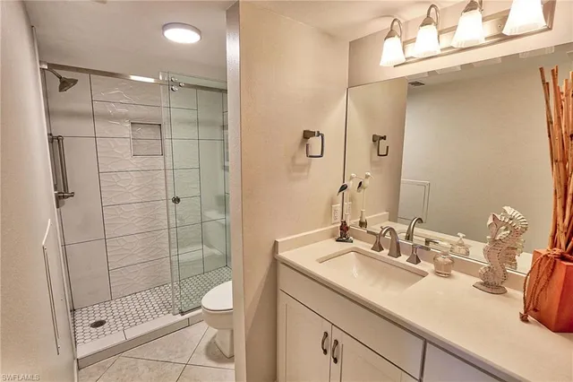 a bathroom with a shower a sink and toilet