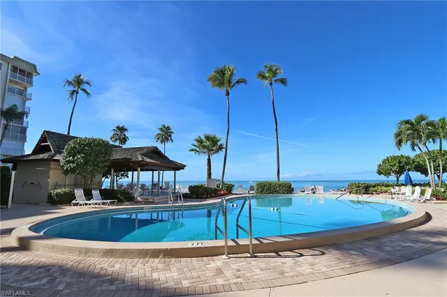 a view of a swimming pool with a table and chairs