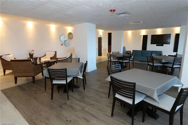a view of a a dining room with furniture window and wooden floor