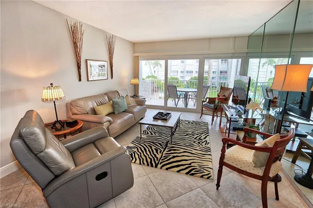 a living room with furniture a large window and a flat screen tv