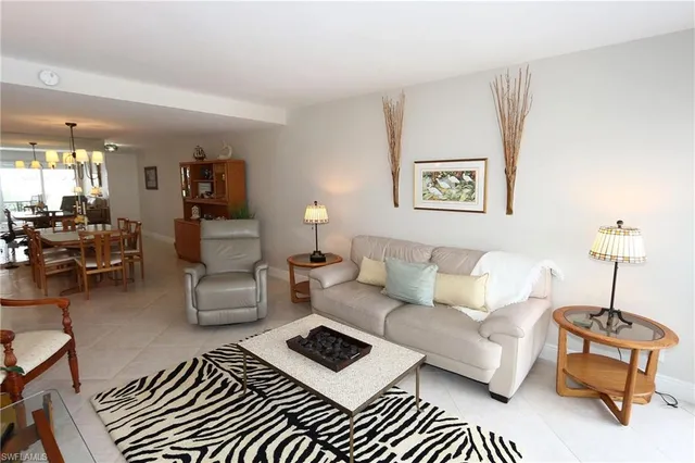 a living room with furniture and a lamp