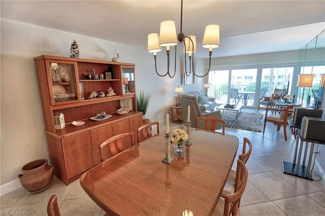a dining room with wooden floor table and chairs