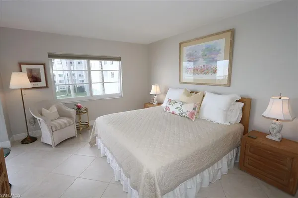 a bedroom with bed and window