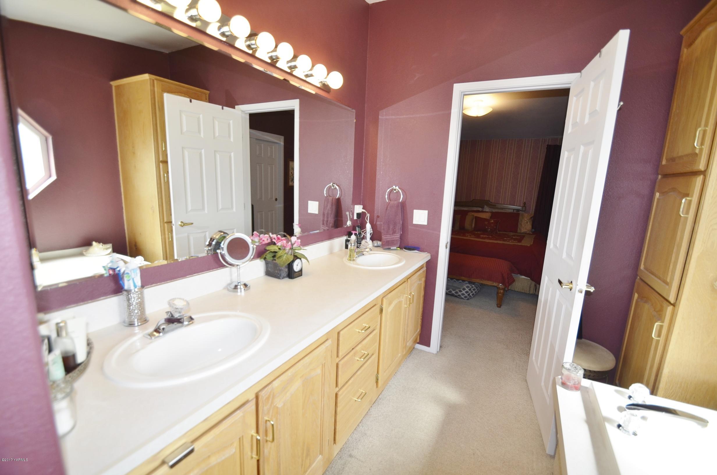 1454 Konnowac Pass Road Moxee, WA 98936 - Photo 11 of 34 a en suite bathroom with a double vanity sink and a mirror