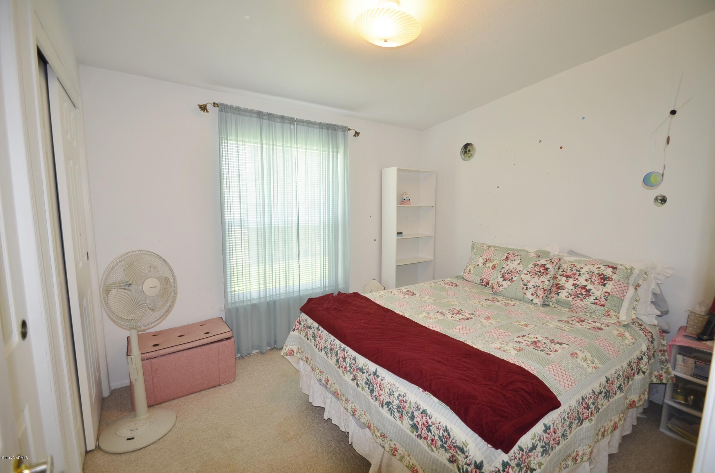 1454 Konnowac Pass Road Moxee, WA 98936 - Photo 15 of 34 a bedroom with a bed and wooden floor
