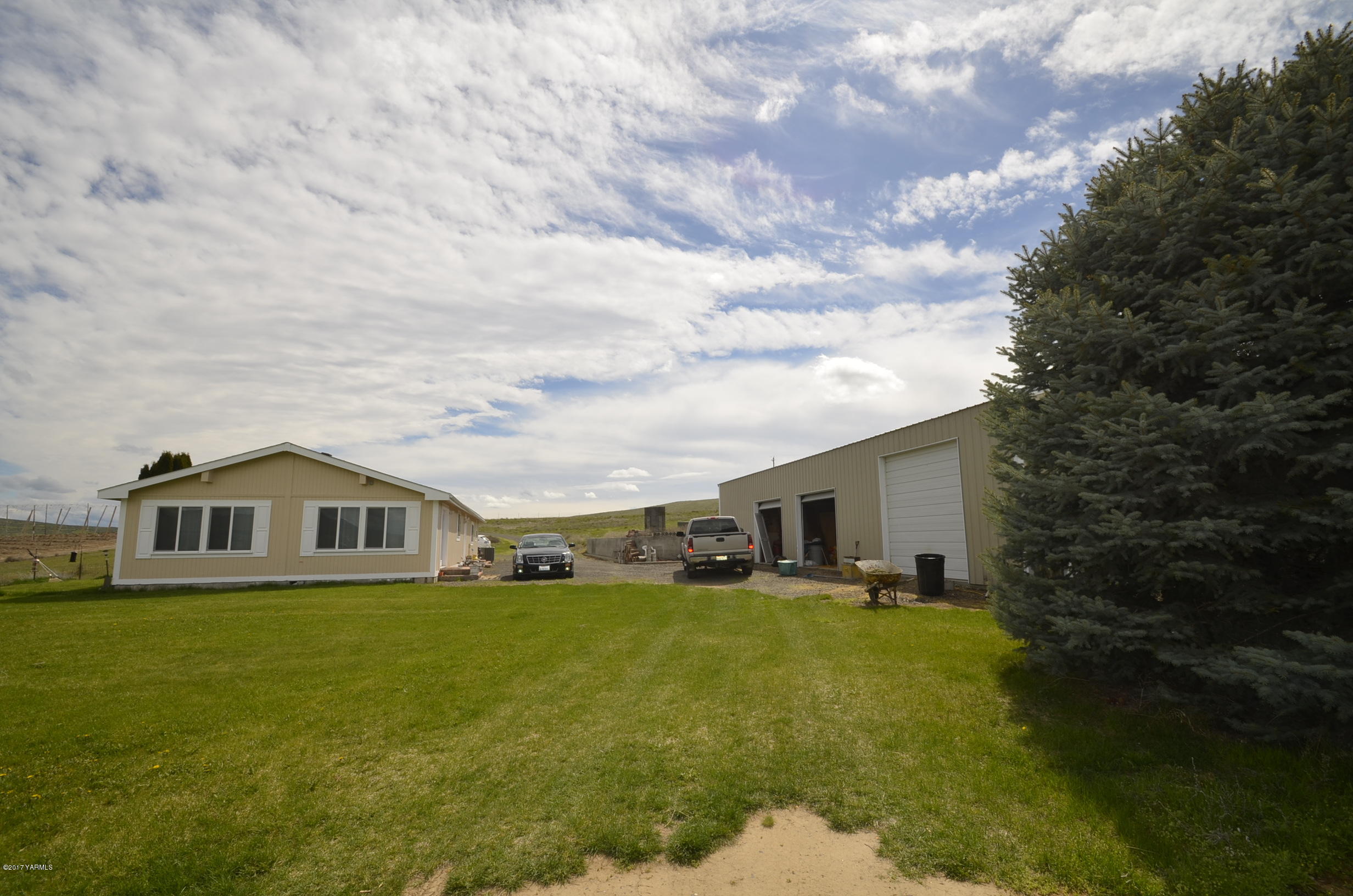 1454 Konnowac Pass Road Moxee, WA 98936 - Photo 3 of 34 a big white house with a big yard and large trees