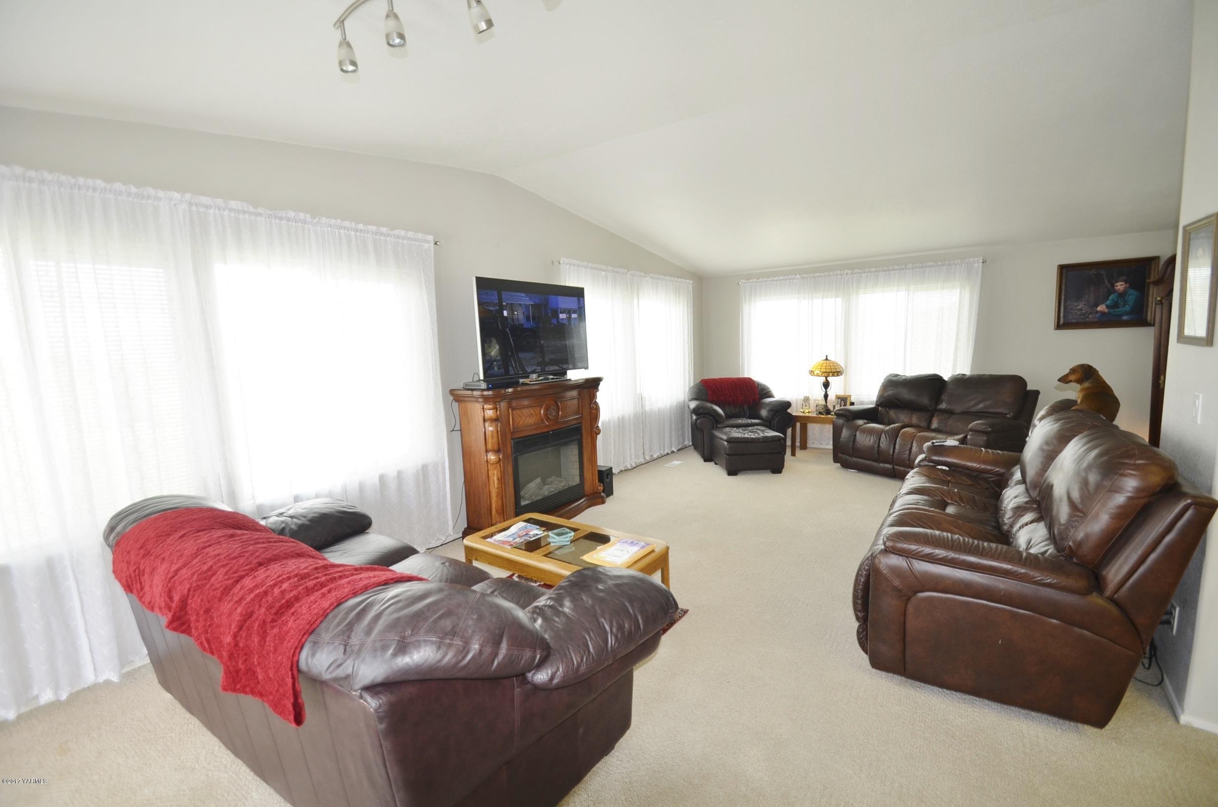 1454 Konnowac Pass Road Moxee, WA 98936 - Photo 31 of 34 a living room with furniture a flat screen tv and a window