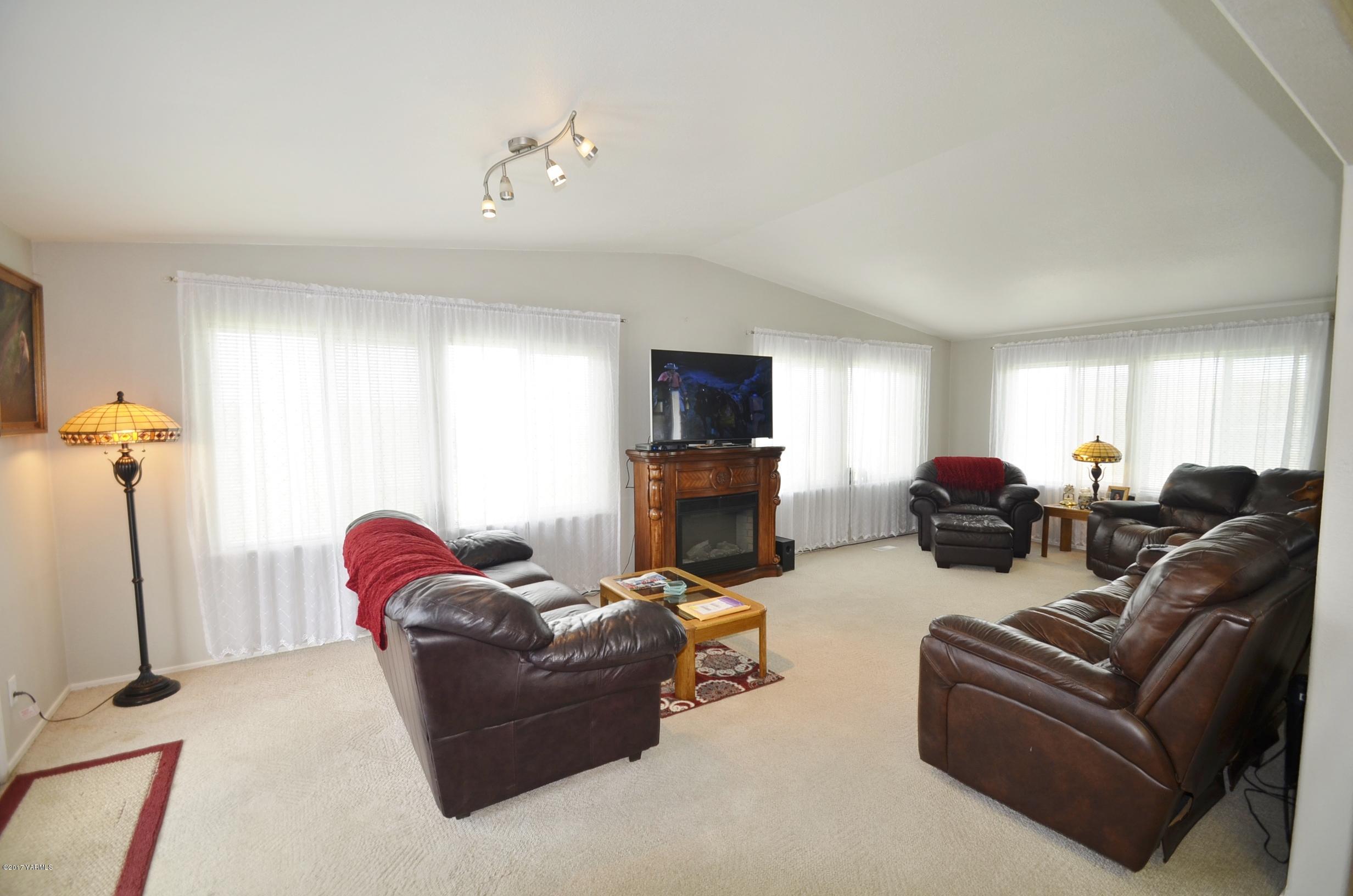 1454 Konnowac Pass Road Moxee, WA 98936 - Photo 6 of 34 a living room with furniture a flat screen tv and a window