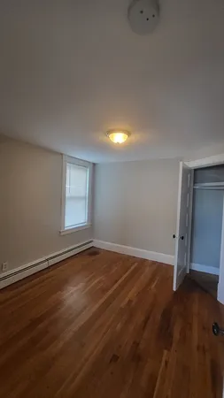 a view of an empty room and wooden floor