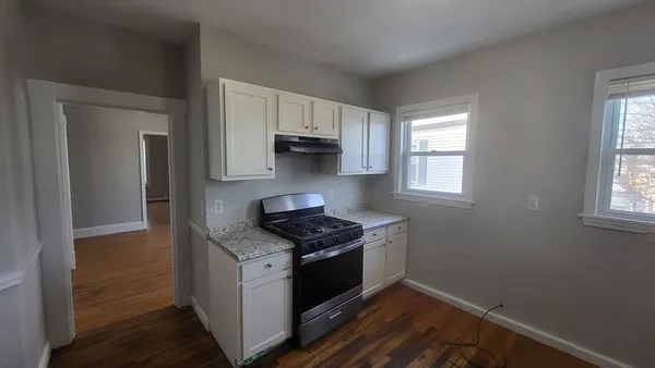 a kitchen with a sink cabinets and window
